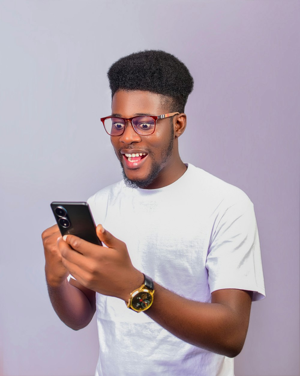 A smiling man reading a message on his phone